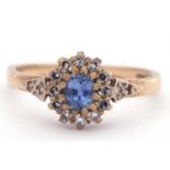 9ct gold sapphire and diamond cluster ring, the pale oval shaped sapphire multi-claw set and