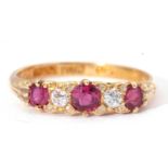 Antique ruby and diamond ring featuring three round graduated rubies and two small old cut diamonds,