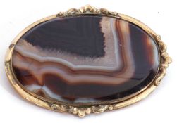 Antique large banded agate brooch, 65 x 50mm, oval shape and framed in a plain scroll yellow metal