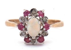 9ct gold opal, diamond and ruby set ring, the oval cabochon opal raised above a small ruby and