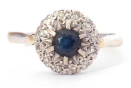18ct white gold, sapphire and diamond cluster ring, the round central sapphire raised above a