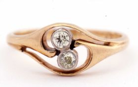 Two-stone diamond ring of openwork design, the centre with opposite bezel set round old brilliant