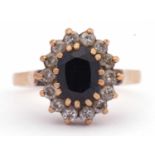 9ct gold sapphire and diamond cluster ring, the oval faceted sapphire raised above a small round