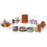 Nine modern white metal rings to include four amber examples