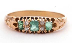 Green stone and small diamond ring featuring three pale green stones highlighted between with