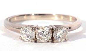 Three stone diamond ring featuring three round brilliant cut diamonds, 0.20ct each approx, raised in