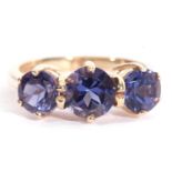 Modern 9ct gold blue three stone ring having three round graduated blue stones raised in coronet