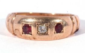 Diamond and ruby three stone ring centring an old cut diamond flanked by two round cut rubies,