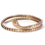 Vintage steel core and 9ct gold serpent bangle, the engraved snakes head and neck joined to a chased