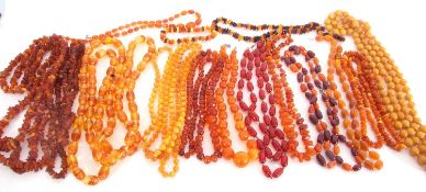 Box full of amber beads and simulated amber wares including necklaces, rings, bracelets etc