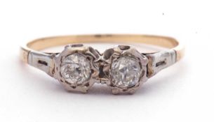 Two-stone diamond ring featuring two old cut diamonds, each in illusion settings, raised between