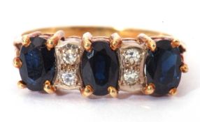 18ct gold dark sapphire and diamond ring, a design featuring three oval cut sapphires, highlighted