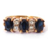 18ct gold dark sapphire and diamond ring, a design featuring three oval cut sapphires, highlighted