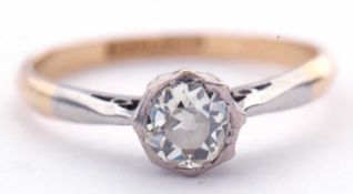 Antique diamond single stone ring featuring an old cut diamond in a rub-over setting, raised between