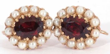 Pair of garnet and seed pearl cluster earrings with screw fittings, stamped 9ct