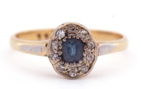 Sapphire and diamond cluster ring, the cushion shaped sapphire surrounded by ten small old cut