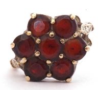 9ct gold and garnet cluster ring, a flowerhead design featuring seven small round faceted garnets,