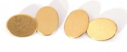 Pair of 18ct stamped cuff links of plain polished design with oval panels with chain connectors