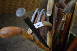 GREEN GLAZED STICK STAND CONTAINING A VARIETY OF WALKING STICKS