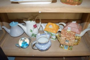 COLLECTION OF DECORATED TEA POTS AND A GLASS PAPERWEIGHT FORMED AS A TEA POT
