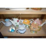 COLLECTION OF DECORATED TEA POTS AND A GLASS PAPERWEIGHT FORMED AS A TEA POT