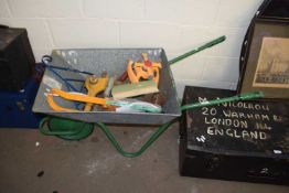 WHEELBARROW CONTAINING VARIOUS GARDEN TOOLS AND HOSE ATTACHMENTS