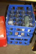 2 crates advertising milk bottles and others