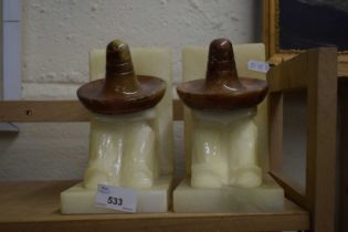 PAIR OF POLISHED ALABASTER BOOKENDS FORMED AS FIGURES IN MEXICAN HATS