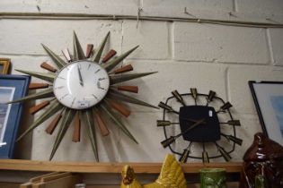 TWO MID-CENTURY WALL CLOCKS, ONE WITH STAR OR SUNBURST DECORATION