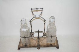 SILVER PLATED SPIRIT DECANTER STAND AND TWO DECANTERS