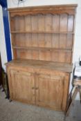 19TH CENTURY PINE DRESSER WITH SHELVED BACK OVER A BASE WITH TWO PANELLED DOORS, 126CM WIDE