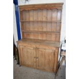 19TH CENTURY PINE DRESSER WITH SHELVED BACK OVER A BASE WITH TWO PANELLED DOORS, 126CM WIDE