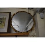 EARLY 20TH CENTURY CIRCULAR BEVELLED WALL MIRROR WITH A GILT FLORAL SURROUND 53CM D