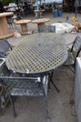 Cast garden dining set comprising table and four chairs, table width 106cm x 180cm