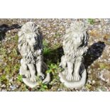 Pair of small composite seated lions, height approx 40cm
