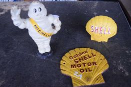 Cast Michelin money box together with a further cast Shell money box and a cast 'Shell motor oli"