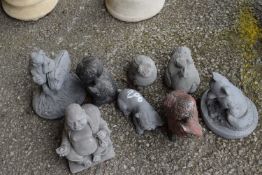Eight small composite garden statues of various designs to include Buddha, frog, fox etc
