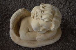 Composite statue of a cherub, width approx 25cm, height 15cm