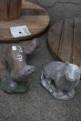 Two composite garden statues, one in the form of an otter, the other a badger