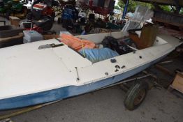 Sailing dinghy, length approx 490cm including accompanying sails, rudders etc, on a trailer