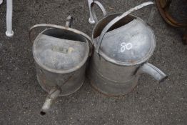 Two galvanised watering cans