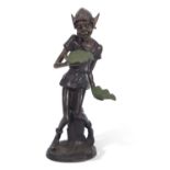 A contemporary bronzed metal model of a pixie holding two leaves, set on a circular base, 77cm high
