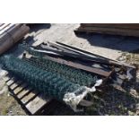Rolled quantity of chainlink fencing with posts