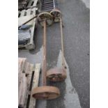 Two cast iron axles, largest width 145cm