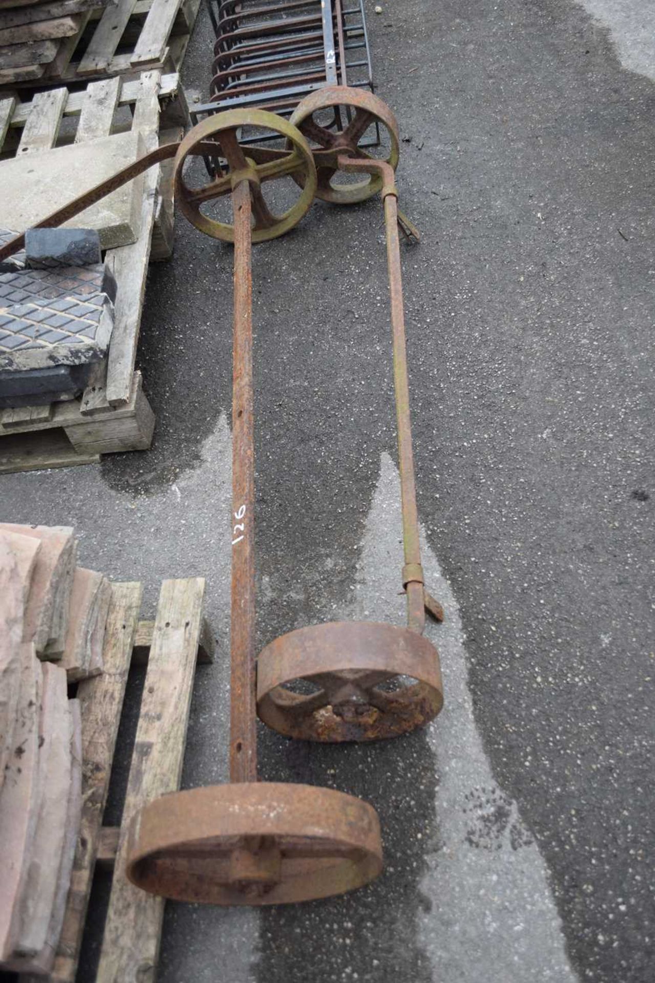Two cast iron axles, largest width 145cm