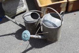 Two galvanised watering cans