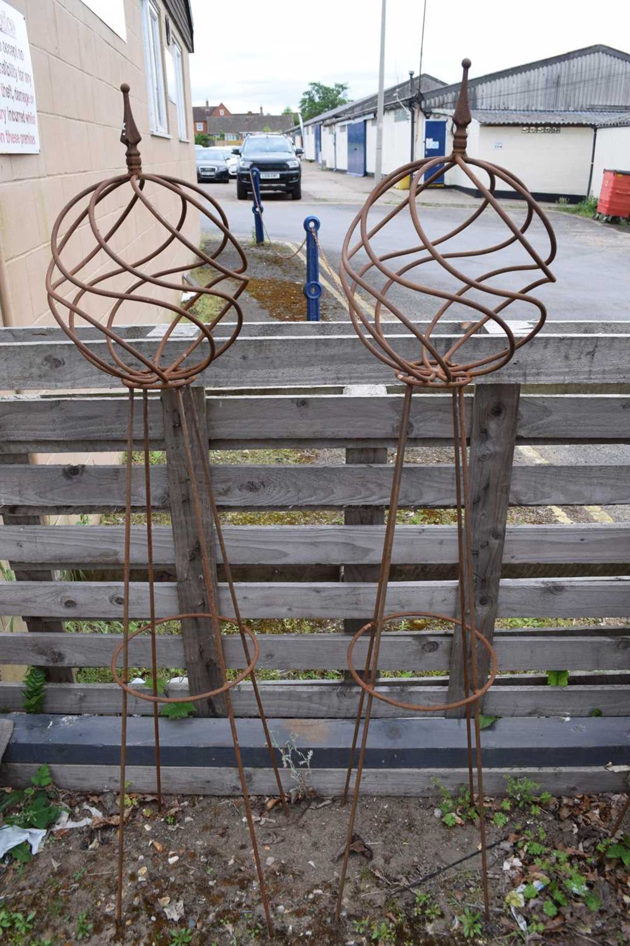Pair of spiral ball topped obelisks, height 160cm