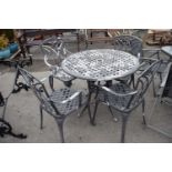 Cast garden dining set comprising a table and four chairs, table approx 90cm diam
