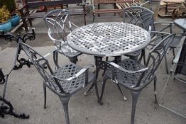 Cast garden dining set comprising a table and four chairs, table approx 90cm diam