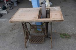 Vintage singer sewing machine attached to a grinding stone, height 76cm, width 92cm x 60cm